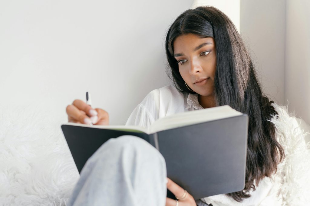 Woman writing in a journal.