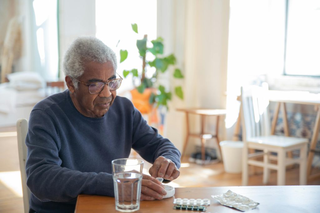 Older man sitting at a table.